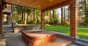 Modern Sunset Spas hot tub in a Goodyear backyard surrounded by desert landscaping and soft lighting.