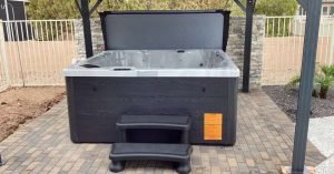 Outdoor hot tub with shade structure in a desert backyard