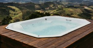 Hot tub in snowy backyard, insulated hot tub for winter, energy-efficient spa in cold climate