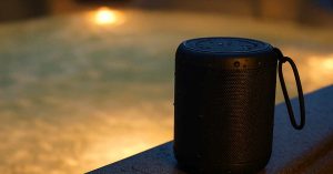 waterproof speaker next to hot tub glowing in evening light