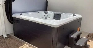 A modern hot tub installed in a backyard patio