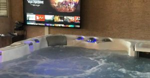 Hot tub spa in backyard setting, jets bubbling