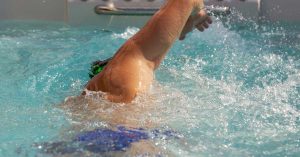Goodyear Arizona homeowner enjoying hydrotherapy jets in swim spa