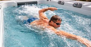 image of person swimming against current in a swim spa for weight loss and cardio fitness
