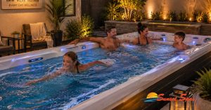 Family enjoying a swim spa at home