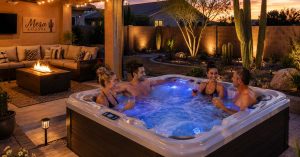 people in a affordable luxury hot tub installed in a Mesa Arizona backyard with comfortable outdoor living space