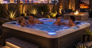 people while using an Energy-efficient luxury hot tub installed in a Las Vegas backyard with modern desert landscaping